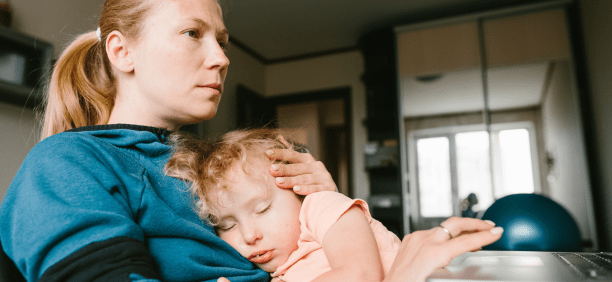 Mother cares for child while working