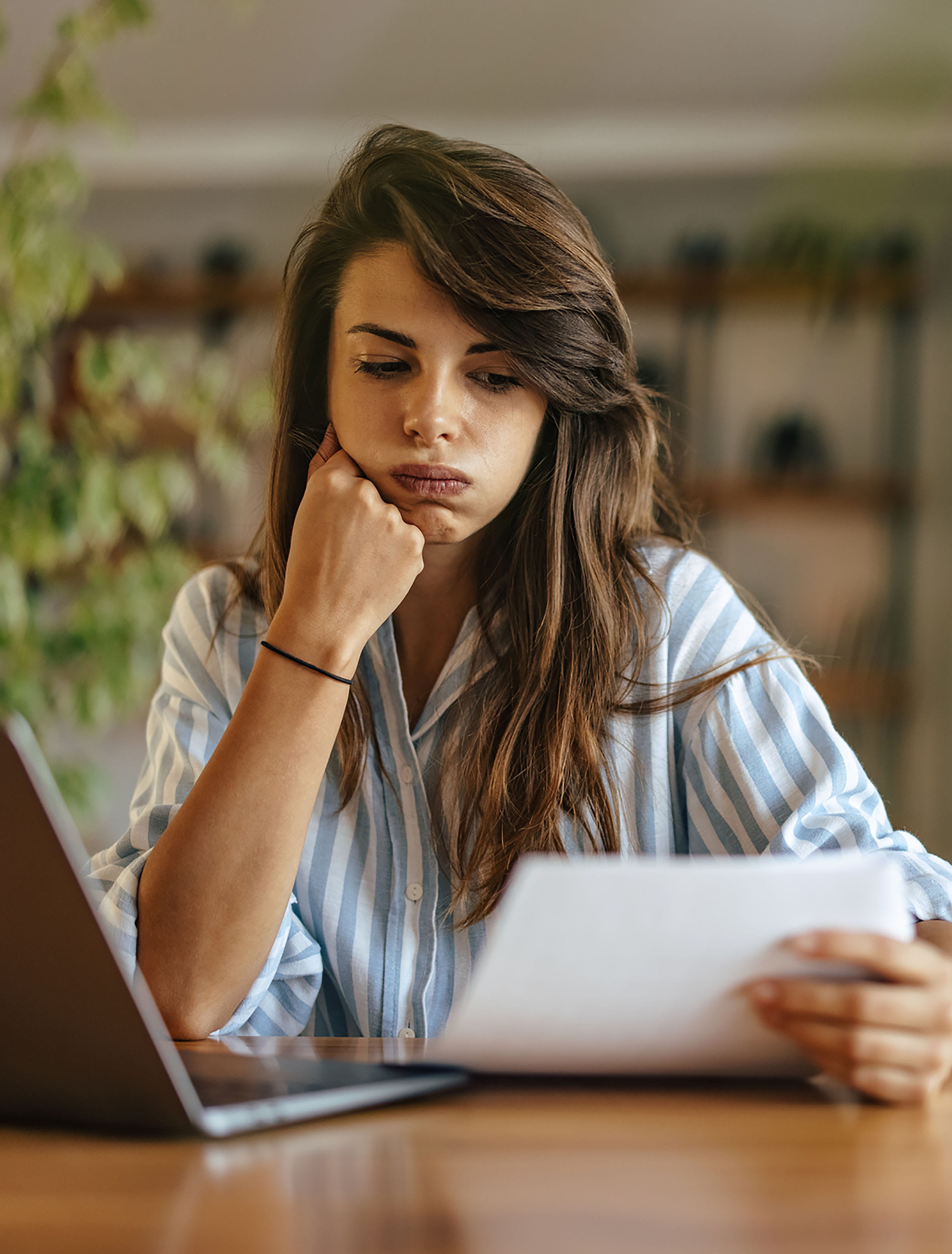 Frustrated woman reading a bill.